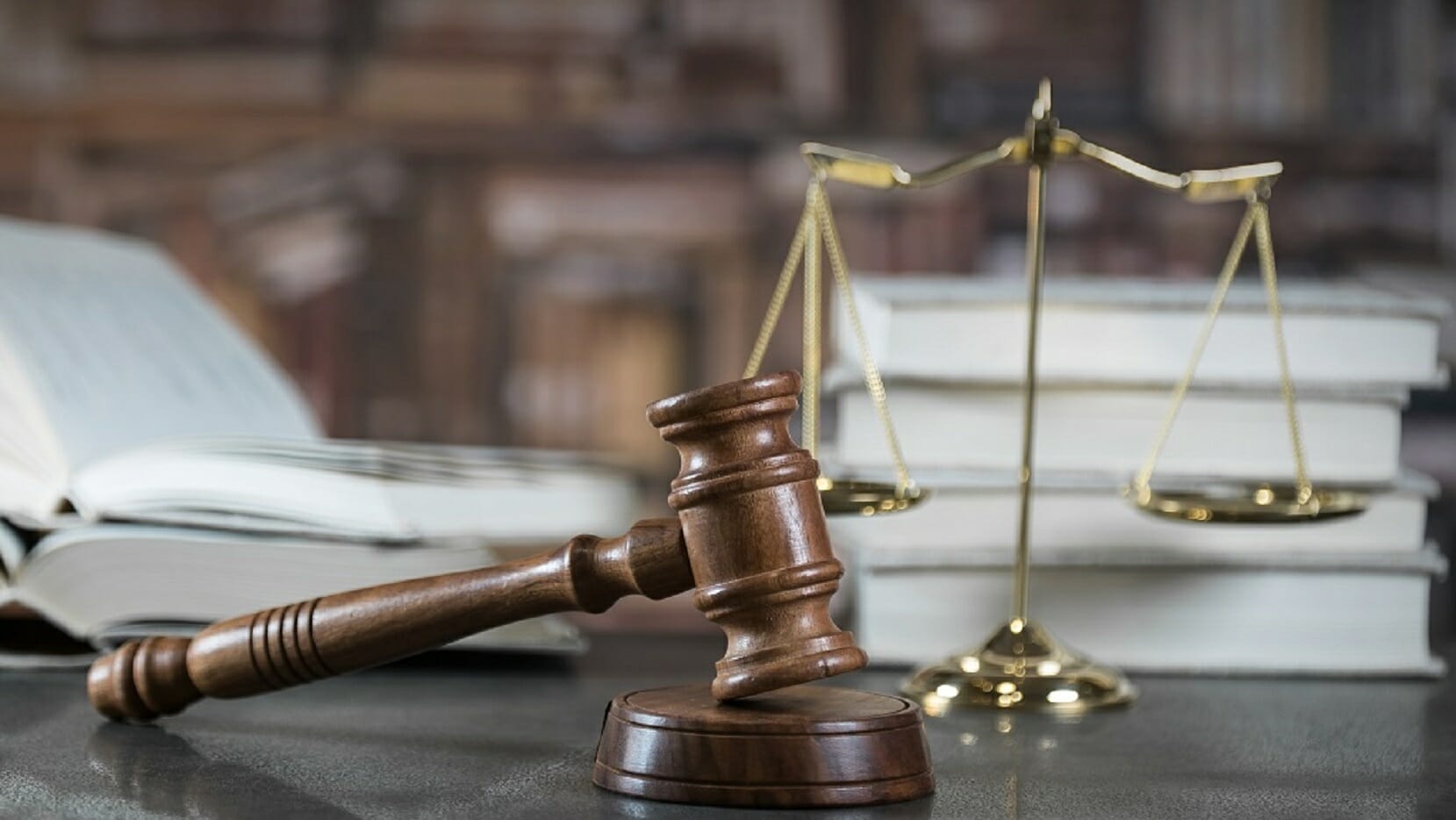 Image of a gavel in front of law books.