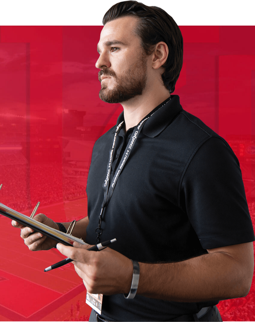 UC Alumni holding a clipboard and pen.