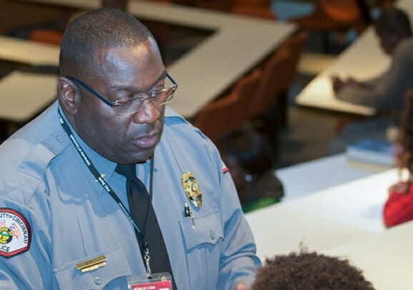 Police officer speaking with criminal justice students.