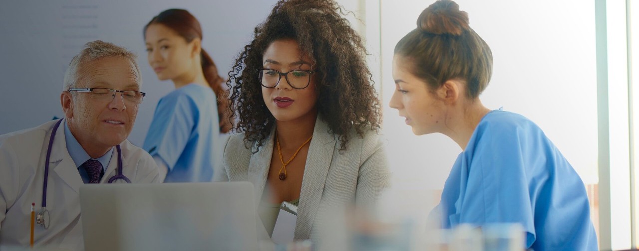 Healthcare professionals looking at a computer.