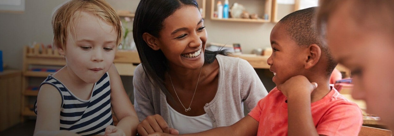 Early childhood education instructor teaching a group of children.